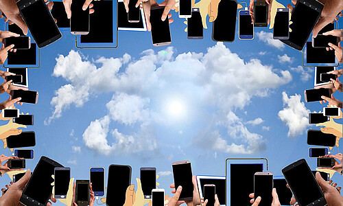 Smartphones am Bildrand, in der Mitte Himmel mit Wolken